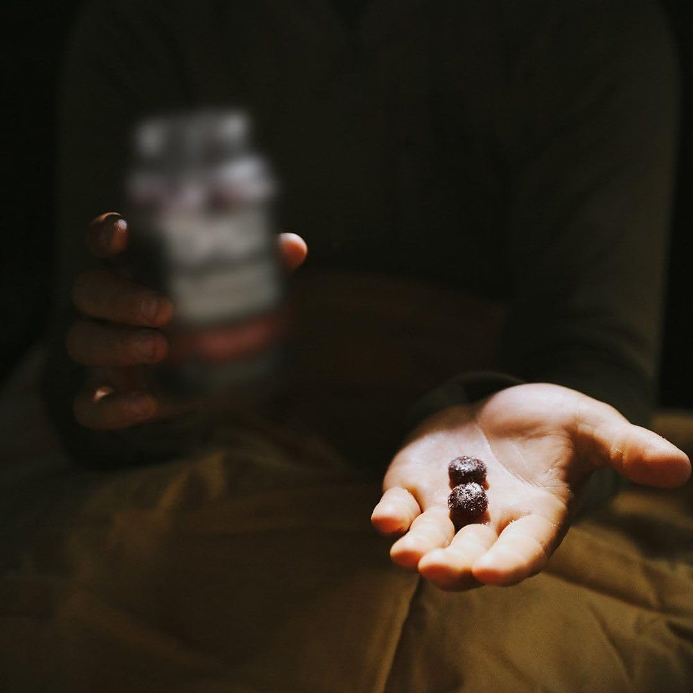MTN OPS Slumber gummies hand-held bottle for travel-friendly sleep support.