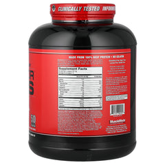 MuscleMeds Carnivor Mass scoop beside tub for easy mixing.