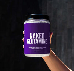 NAKED L-Glutamine micronized powder texture close-up.