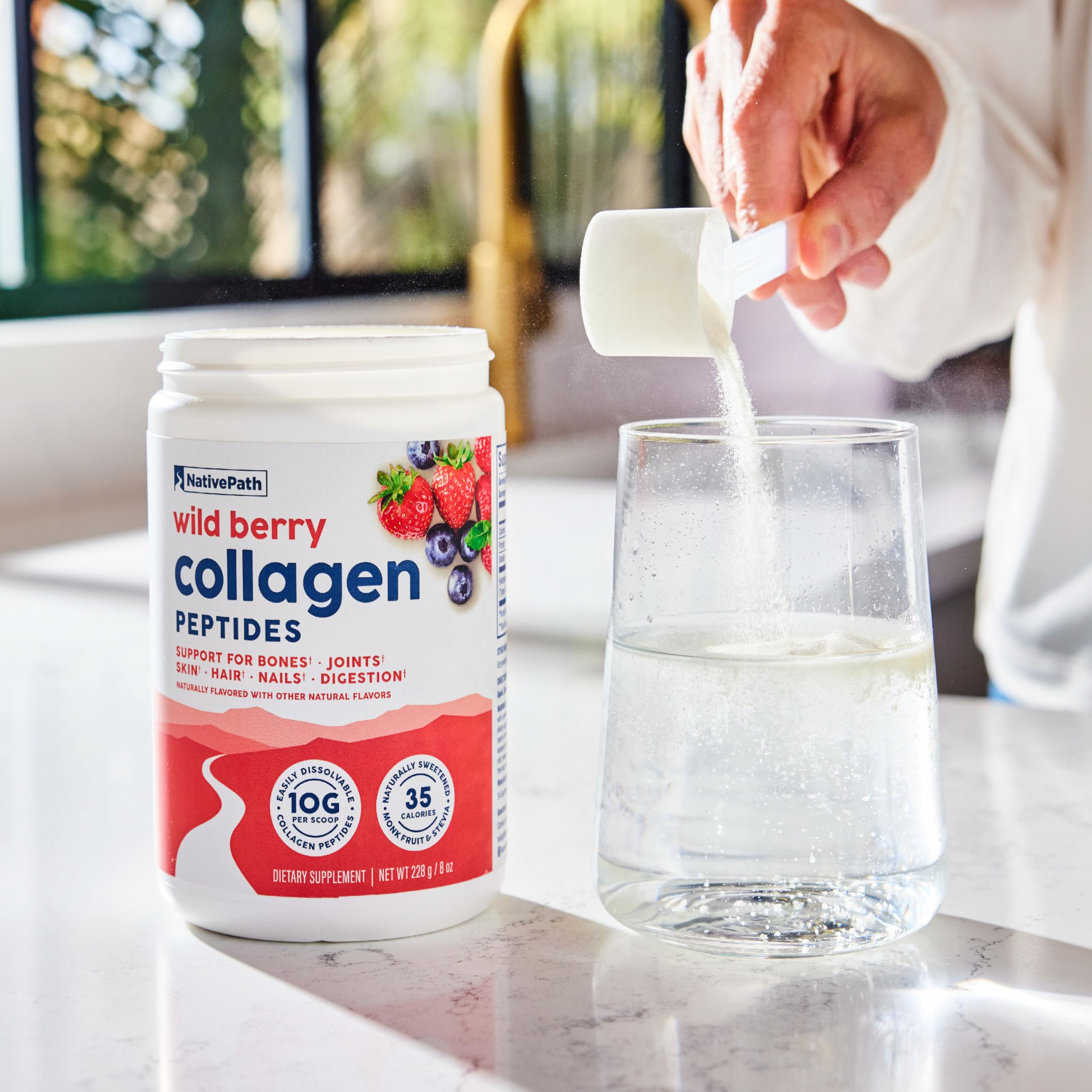 NativePath Wild Berry Collagen on the kitchen counter with fruit.