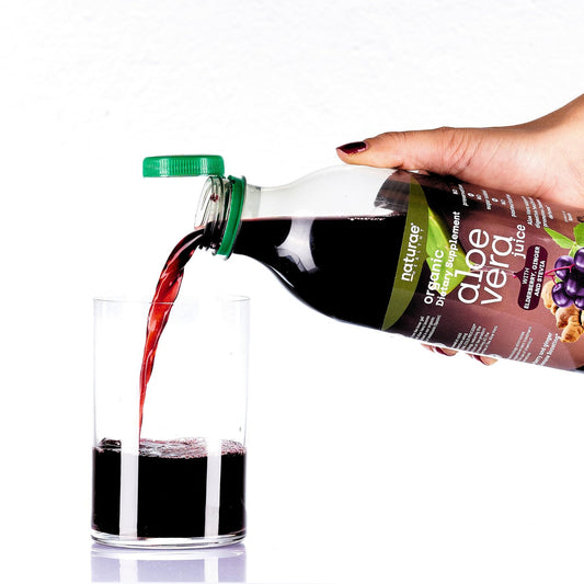 Naturae Aloe Vera with elderberry being poured into a glass for refreshment.