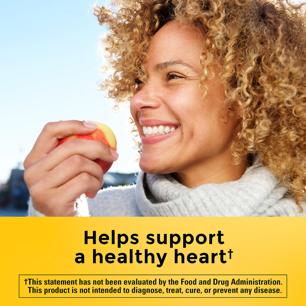 CholestOff Plus softgels in hand show an easy twice-daily routine with meals.