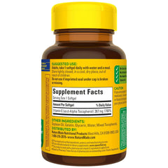 Nature Made Plant Sourced Vitamin E bottle in hand – ready-to-use daily supplement.