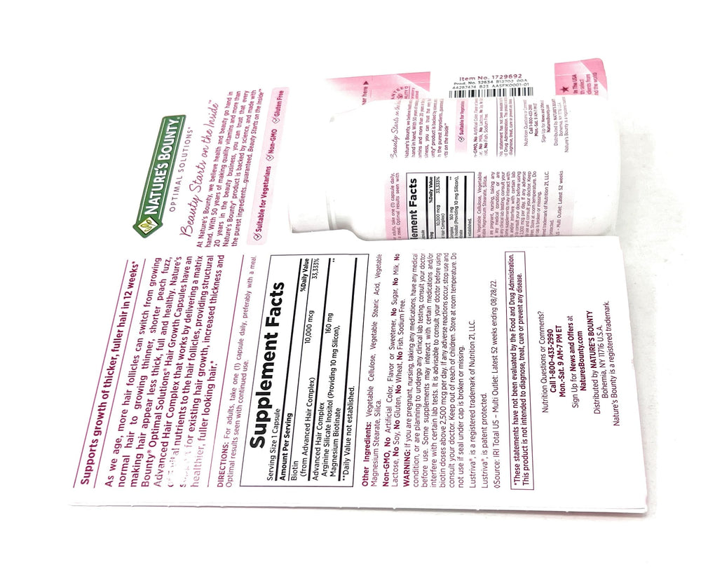 Nature's Bounty Hair Growth bottle with water demonstrates one capsule daily.