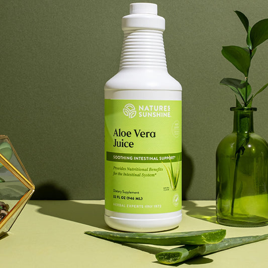 Pouring Nature's Sunshine Aloe Vera Juice into a glass for hydration.