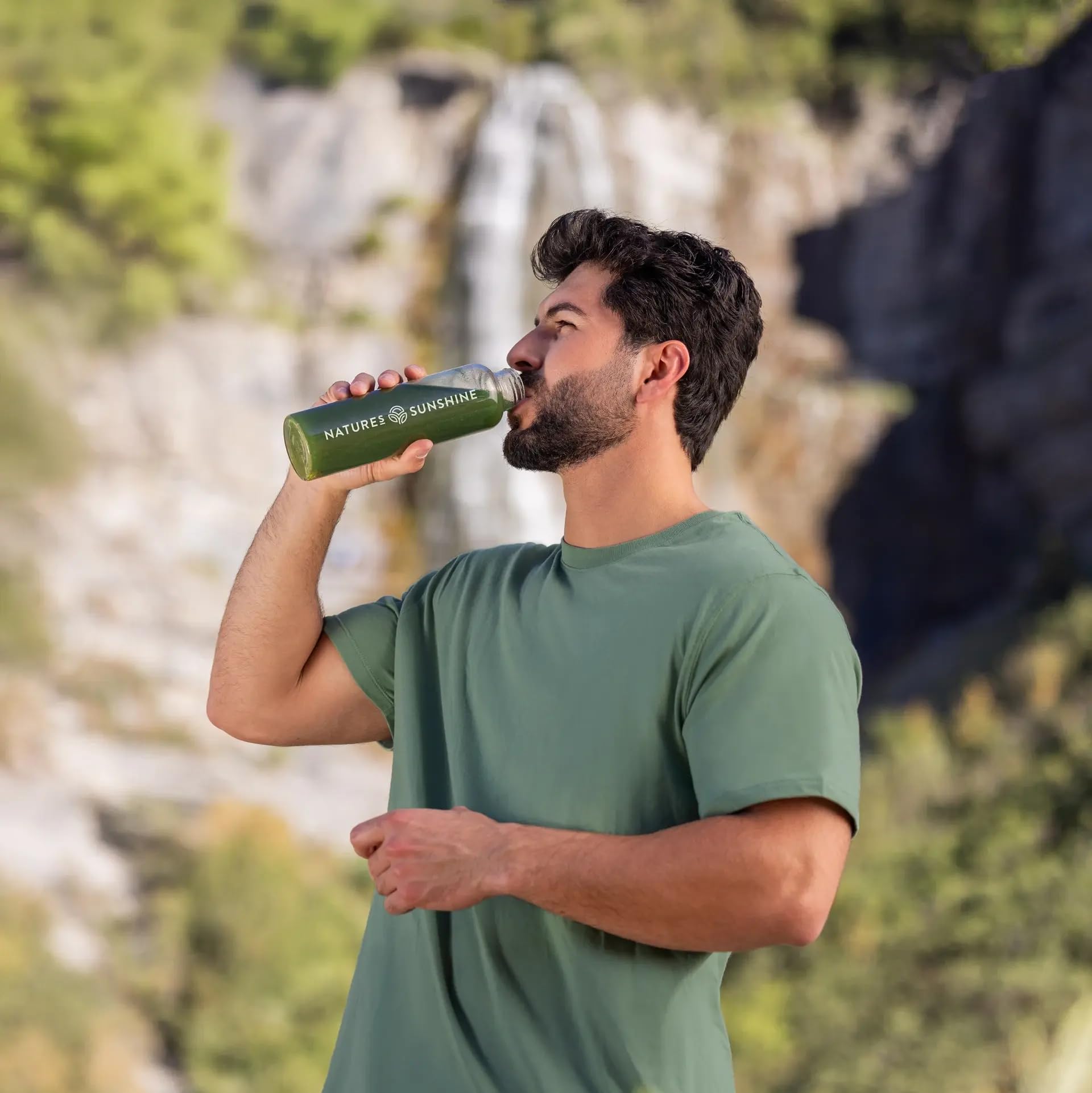 Nature's Sunshine Power Greens in water glass, showing easy mix for healthy daily intake.
