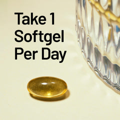 NatureWise D3 + K2 softgels shimmering beside coconut oil on table.