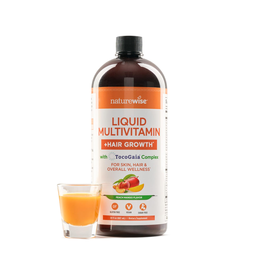 NatureWise liquid multivitamin bottle pouring into a glass to support hair growth