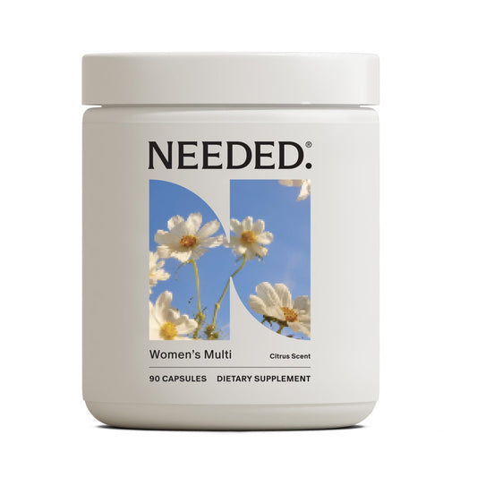 Needed Women’s Multivitamin bottle front with citrus scent insert and daily wellness emphasis