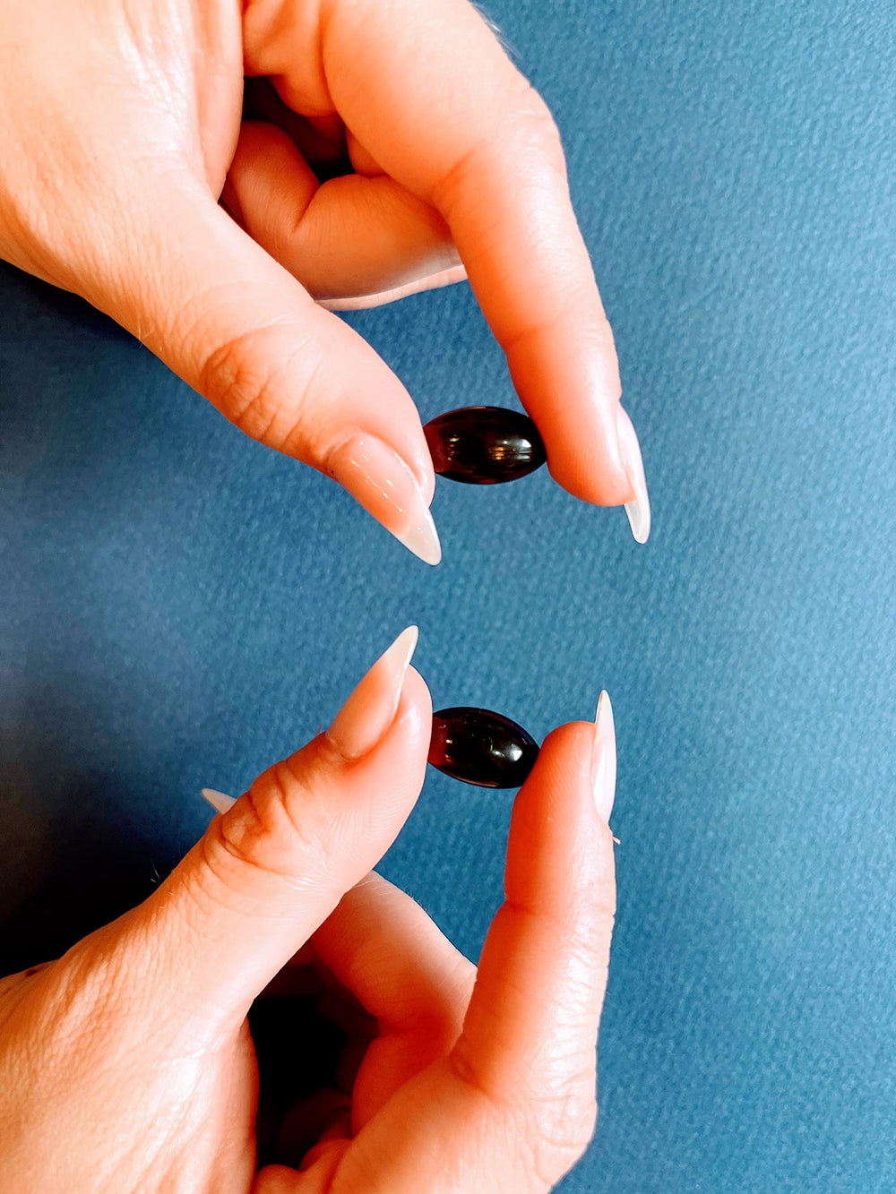 NeuEve softgel capsule texture closeup, smooth and small