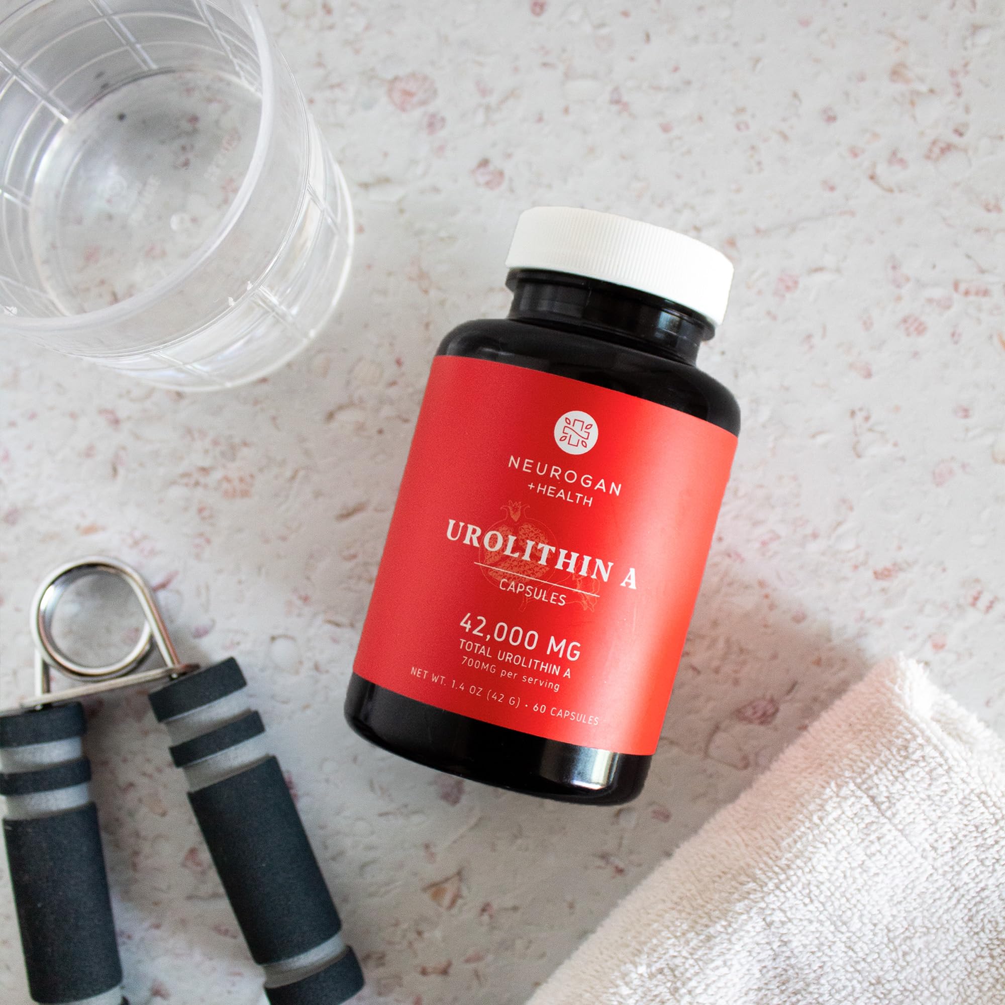 Neurogan Urolithin A lifestyle-use scene with bottle and capsules.