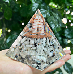 NewMainOne Rainbow Moonstone orgonite pyramid is a gift-ready decorative piece.