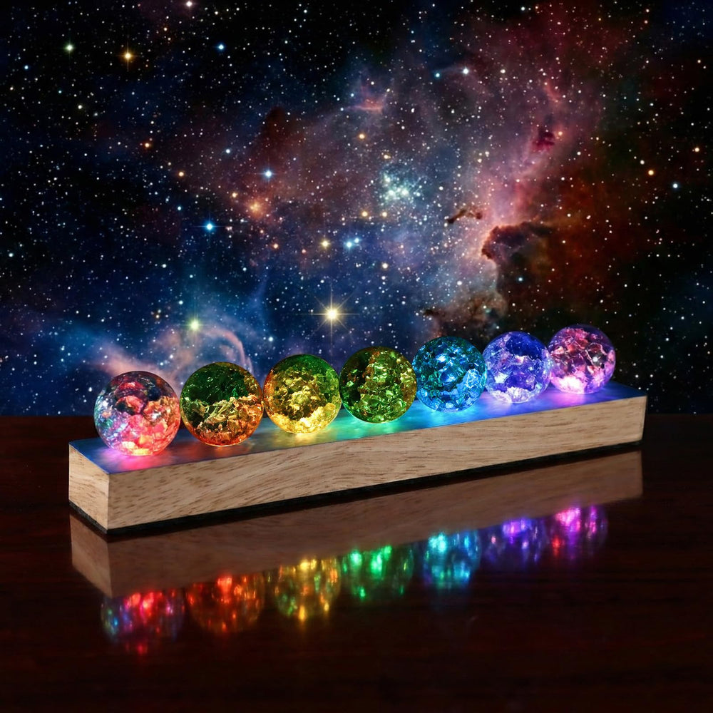 NewRiu 7 chakra spheres arranged on LED stand for meditation ambiance.