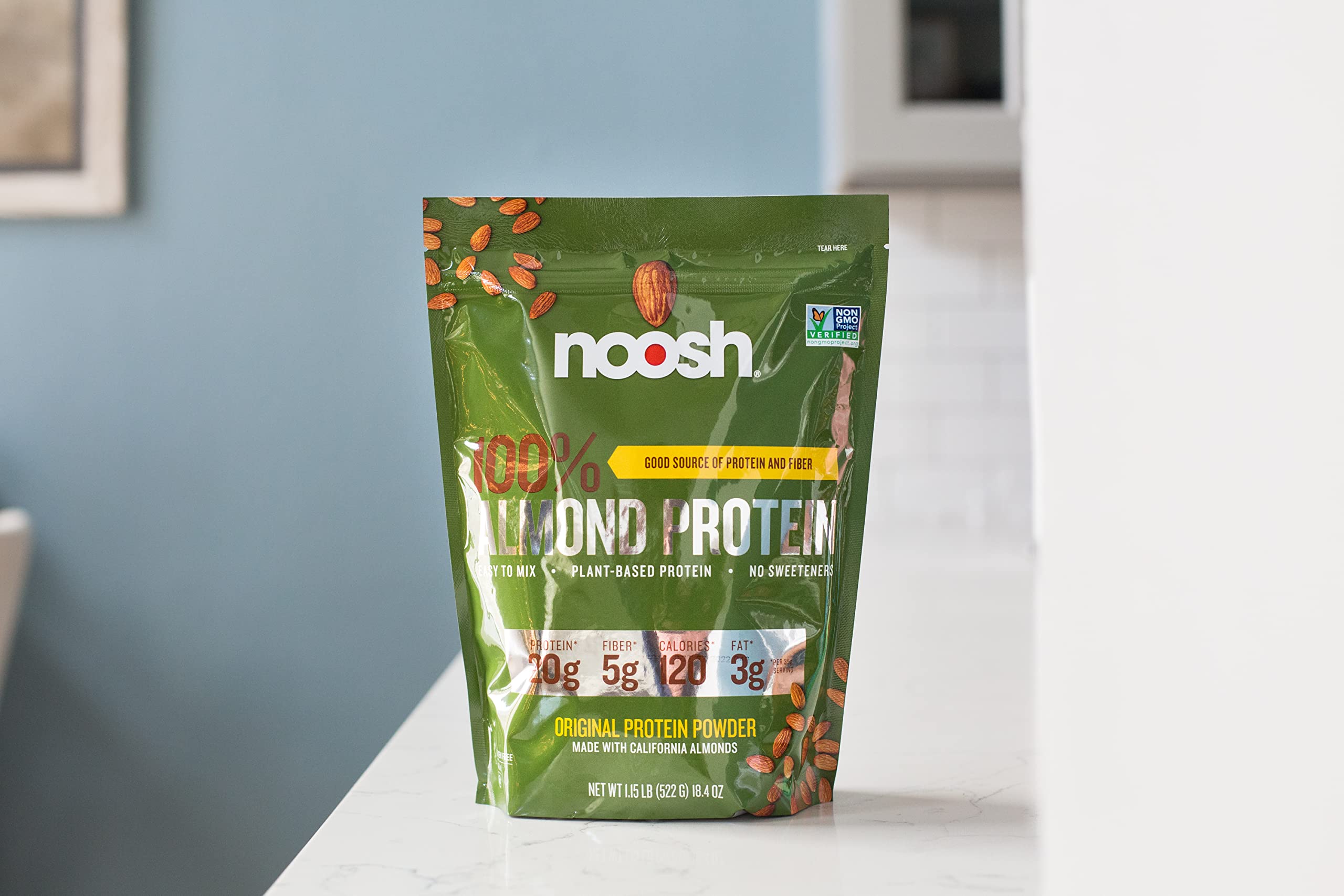 NOOSH almond protein powder poured into glass for a smooth shake