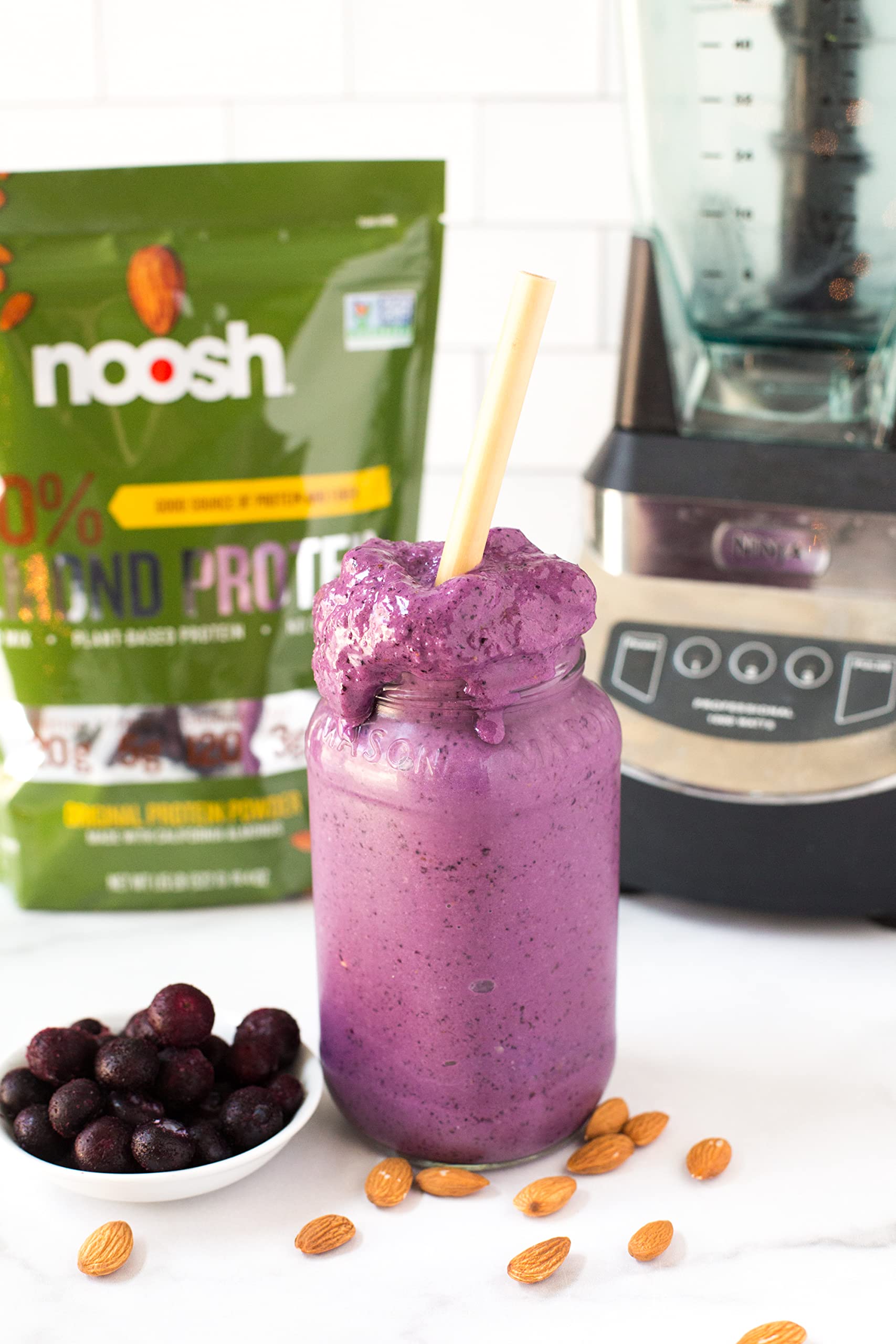 NOOSH powder shown with a smoothie to suggest easy mixing