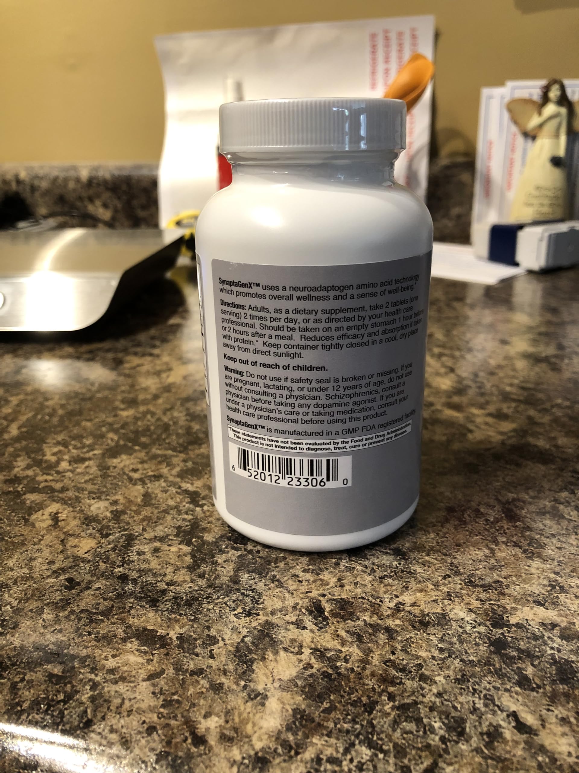Lifestyle scene with SynaptaGenX bottle on a nightstand for mood balance
