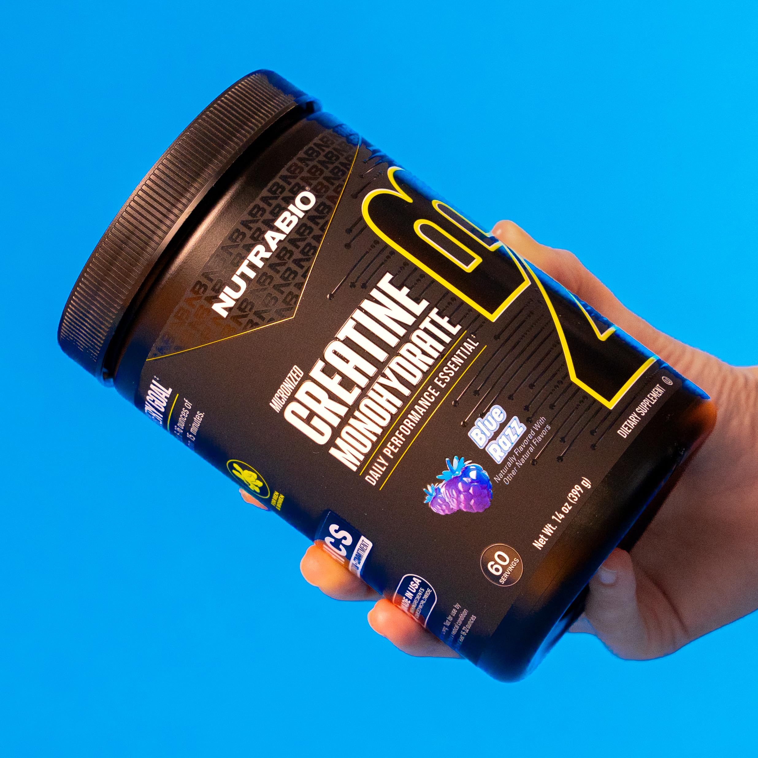 NutraBio Creatine Blue Razz shaker with powder for on the go training.