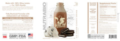 NutraBio Grass Fed Whey Isolate shake in glass, Ice Cream Cookie Dream flavor ready to enjoy.