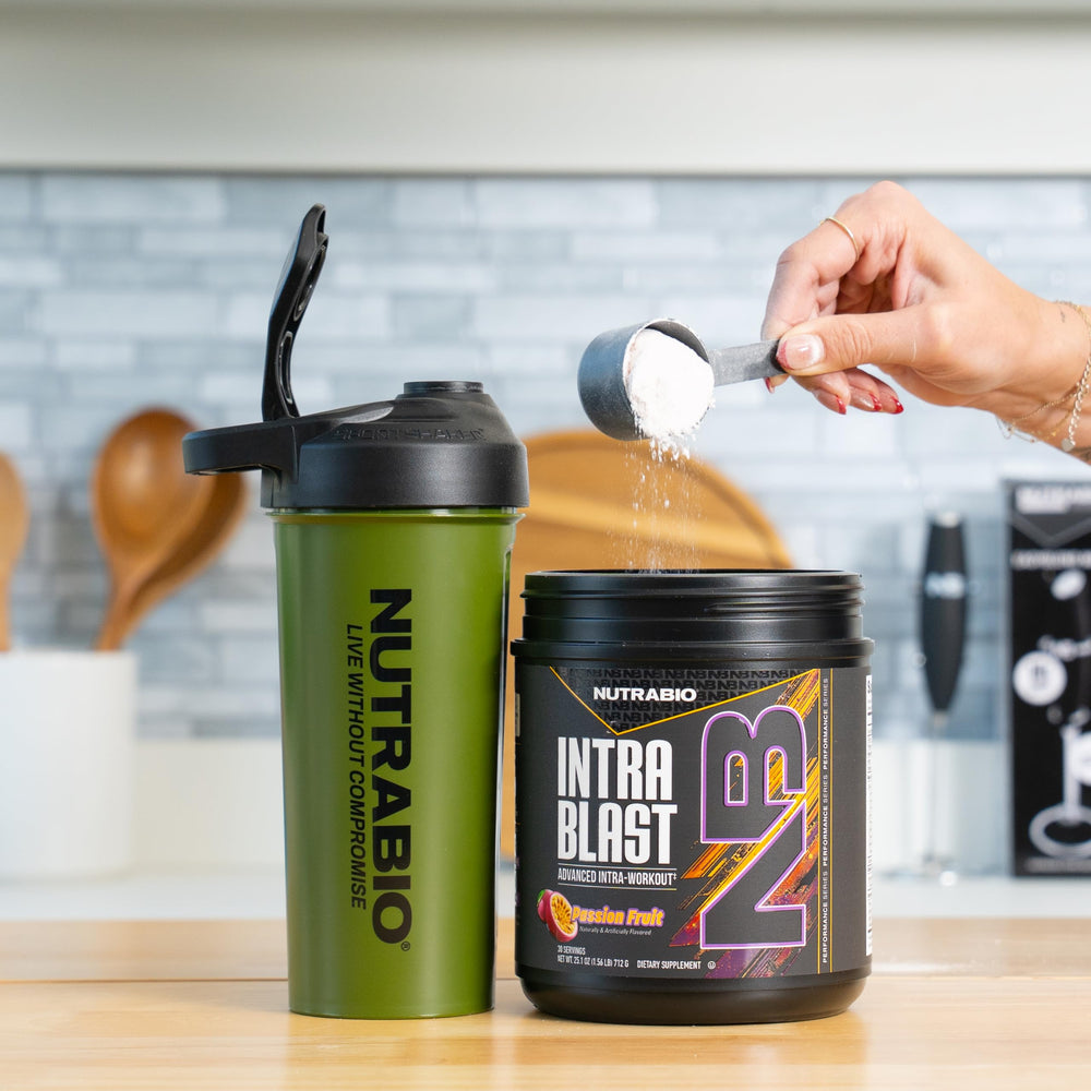 NutraBio Intra Blast dissolving in glass of water mid-workout.