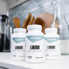 NutraBio Libido bottle on nightstand suggests a consistent vitality routine.