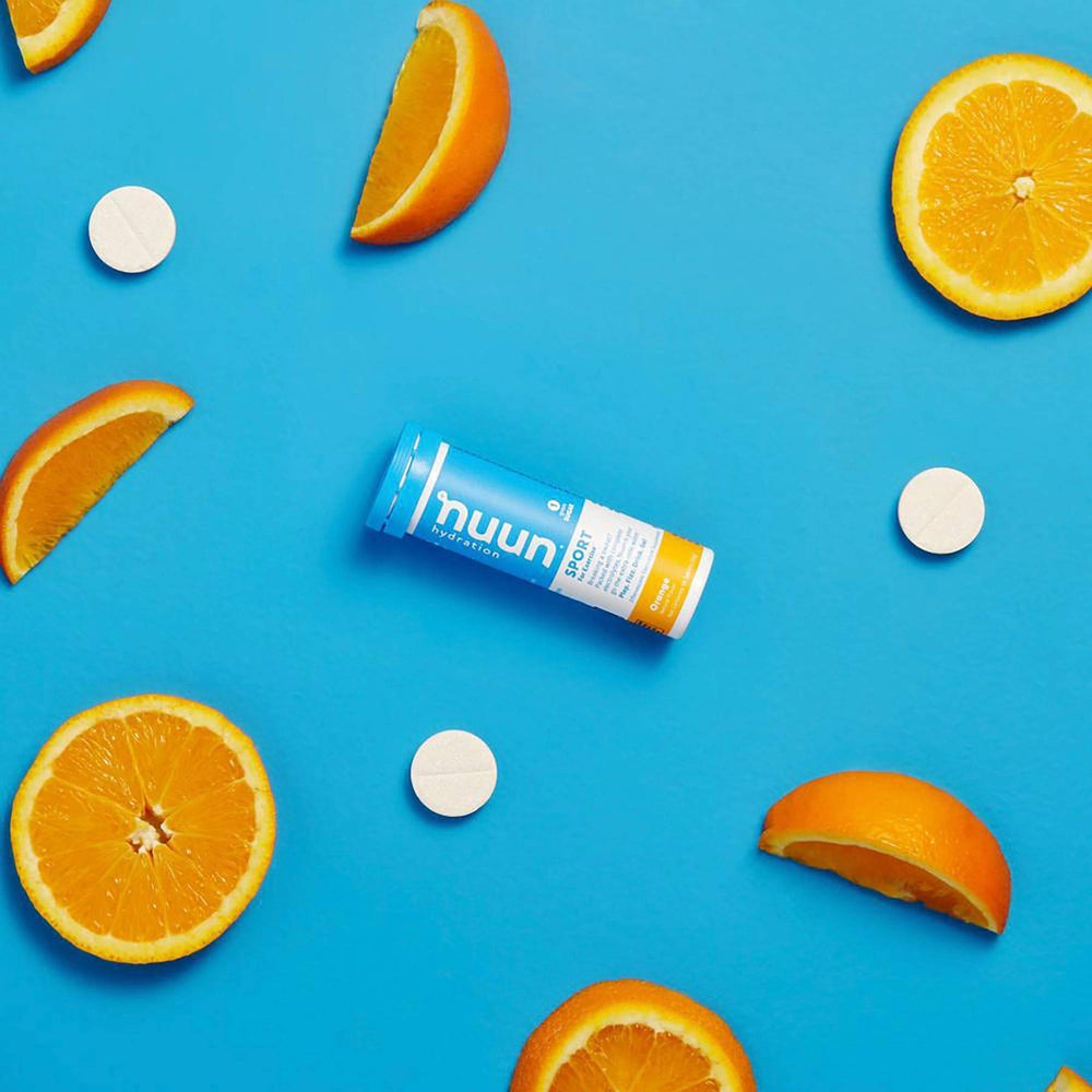 Nuun Sport Orange tablets in a glass of water with bright citrus flavor.