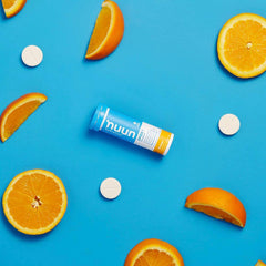 Nuun Sport Orange tablets in a glass of water with bright citrus flavor.