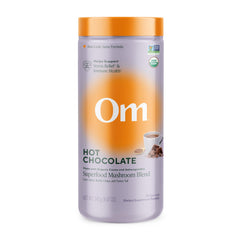 OM Mushroom Superfood hot chocolate canister on a counter, inviting daily ritual