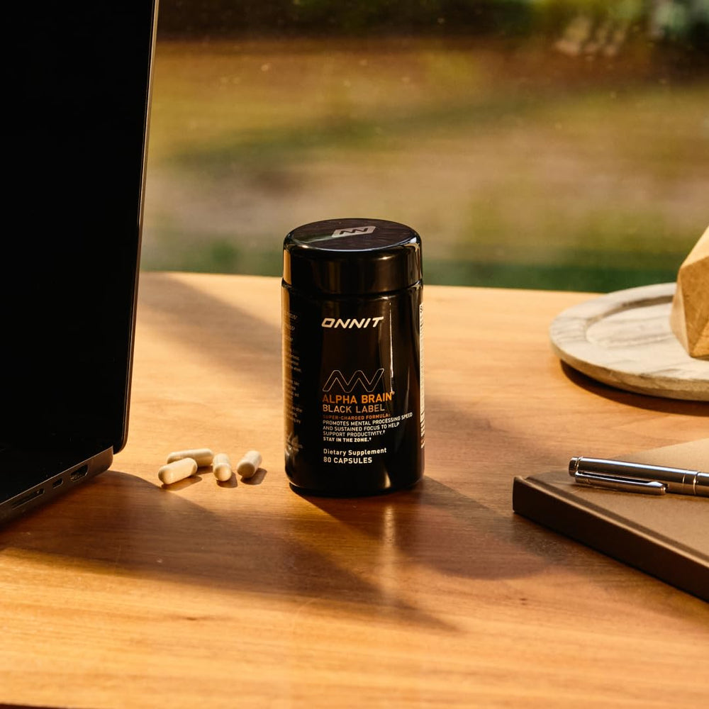 ONNIT Alpha Brain capsules beside coffee for morning alertness.
