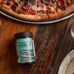 ONNIT Total Gut Health capsules on table during meal