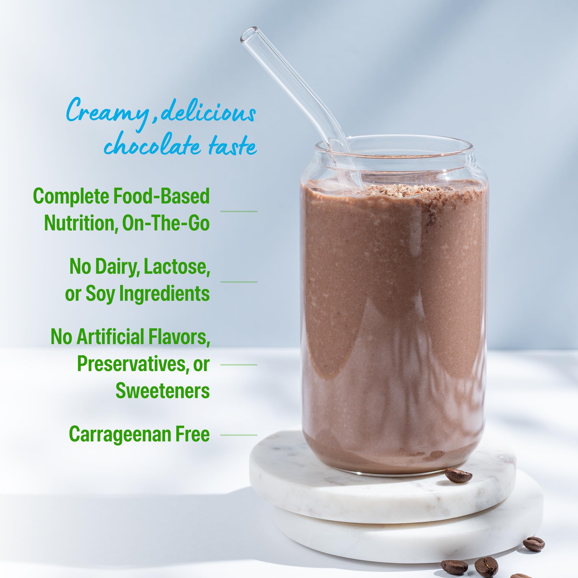 Close-up of Orgain ingredients blend with greens and fruits in view.