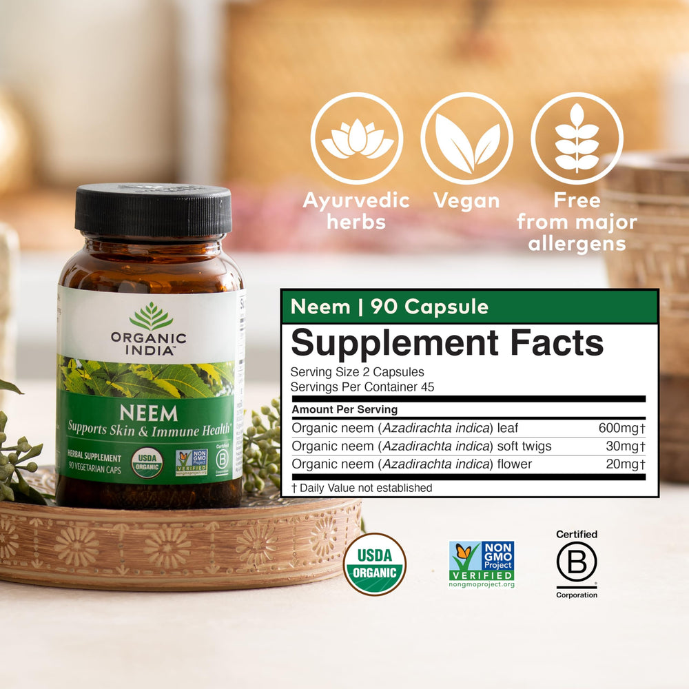 Lifestyle shot with a person using Organic India Neem Leaf Capsules in daily routine.