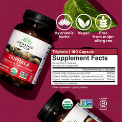 Triphala capsules in hand from Organic India for daily wellness.