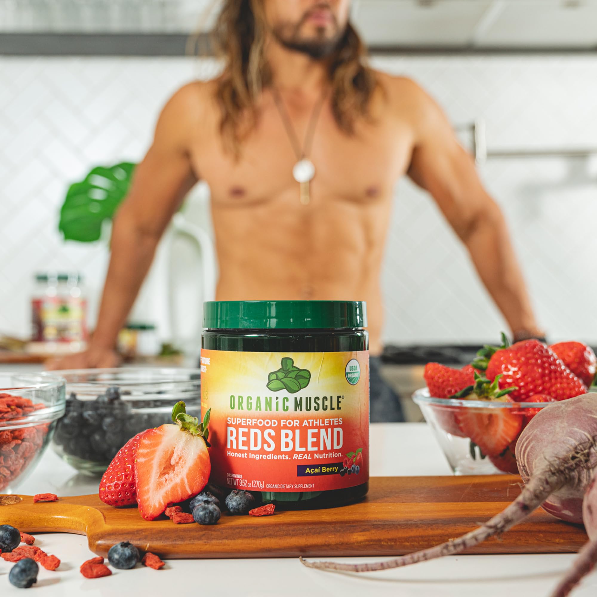 Smoothie bowl blending Organic Muscle Reds Powder into a vibrant red drink.