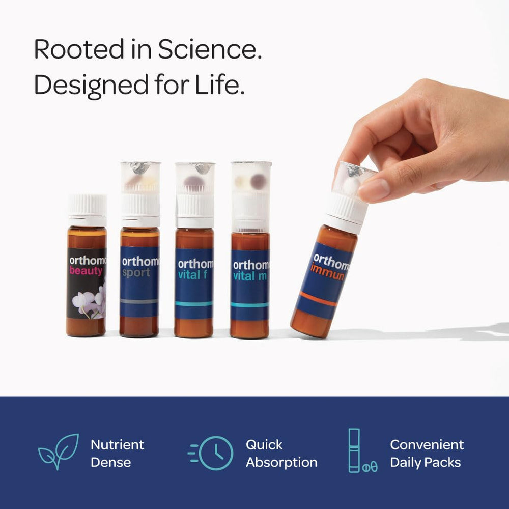 Orthomol Vital F bottle shown beside daily packs on a kitchen counter.