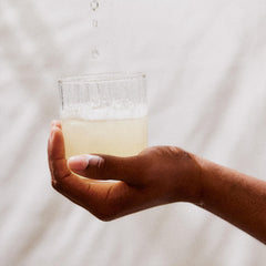 Perelel mango lemonade flavor in a glass