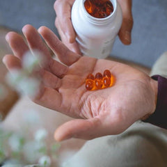 Pharmanex Marine Omega capsules resting on a wooden surface for daily routine