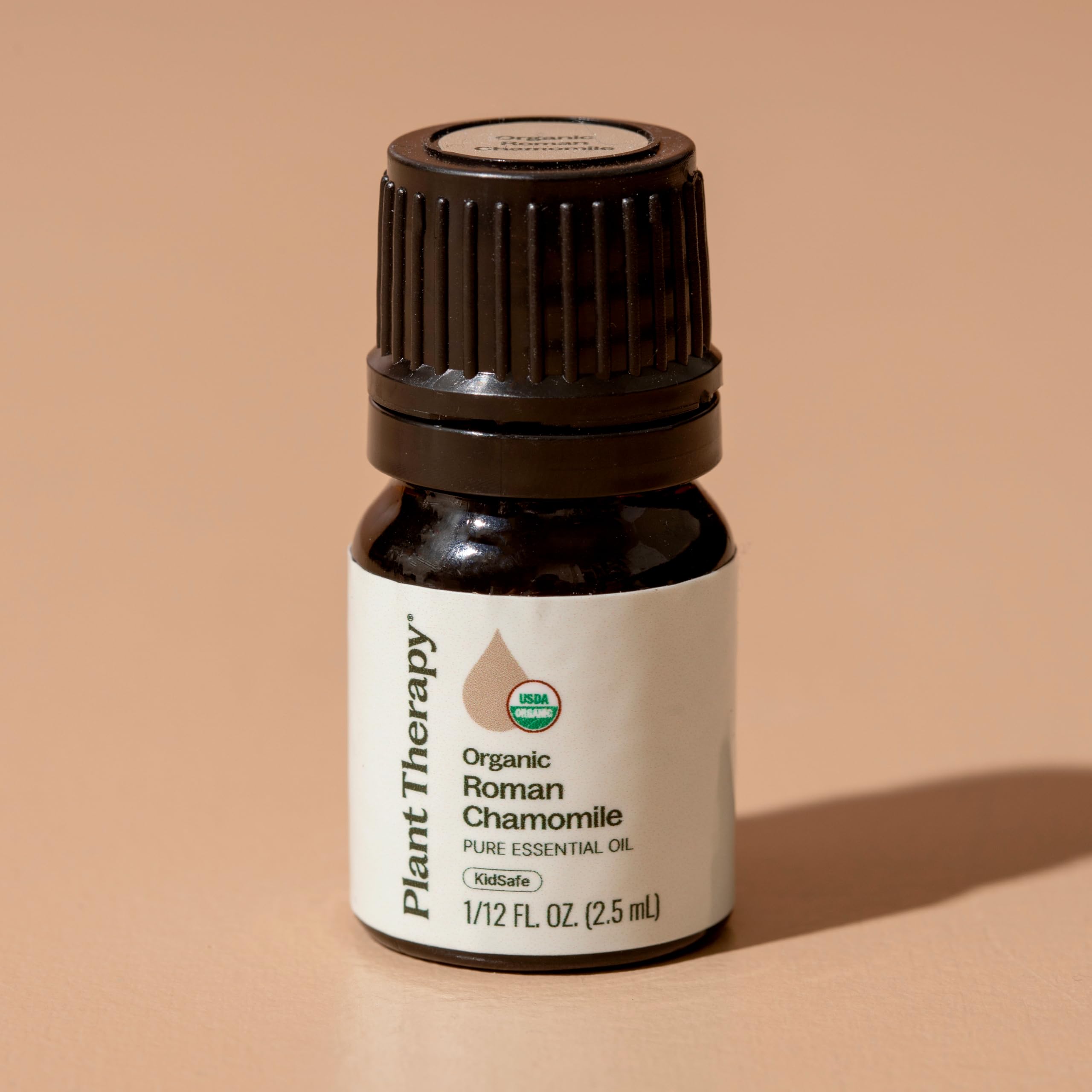 Diluted Plant Therapy Roman Chamomile oil applied to skin for comfort.
