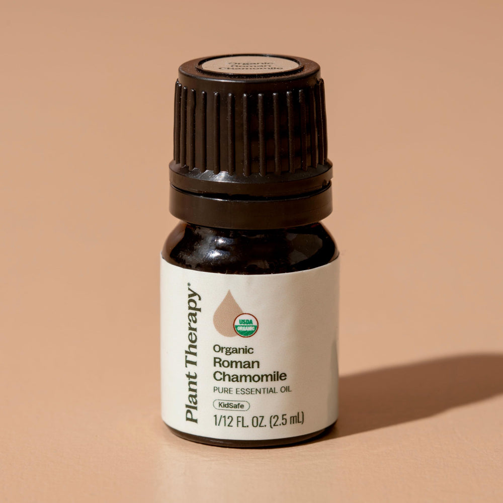 Diluted Plant Therapy Roman Chamomile oil applied to skin for comfort.