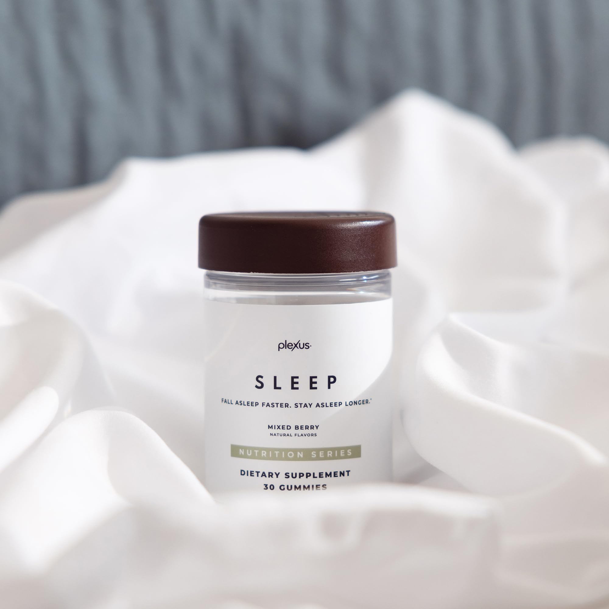 Plexus Sleep bottle with a glass of water suggesting a simple nightly routine.