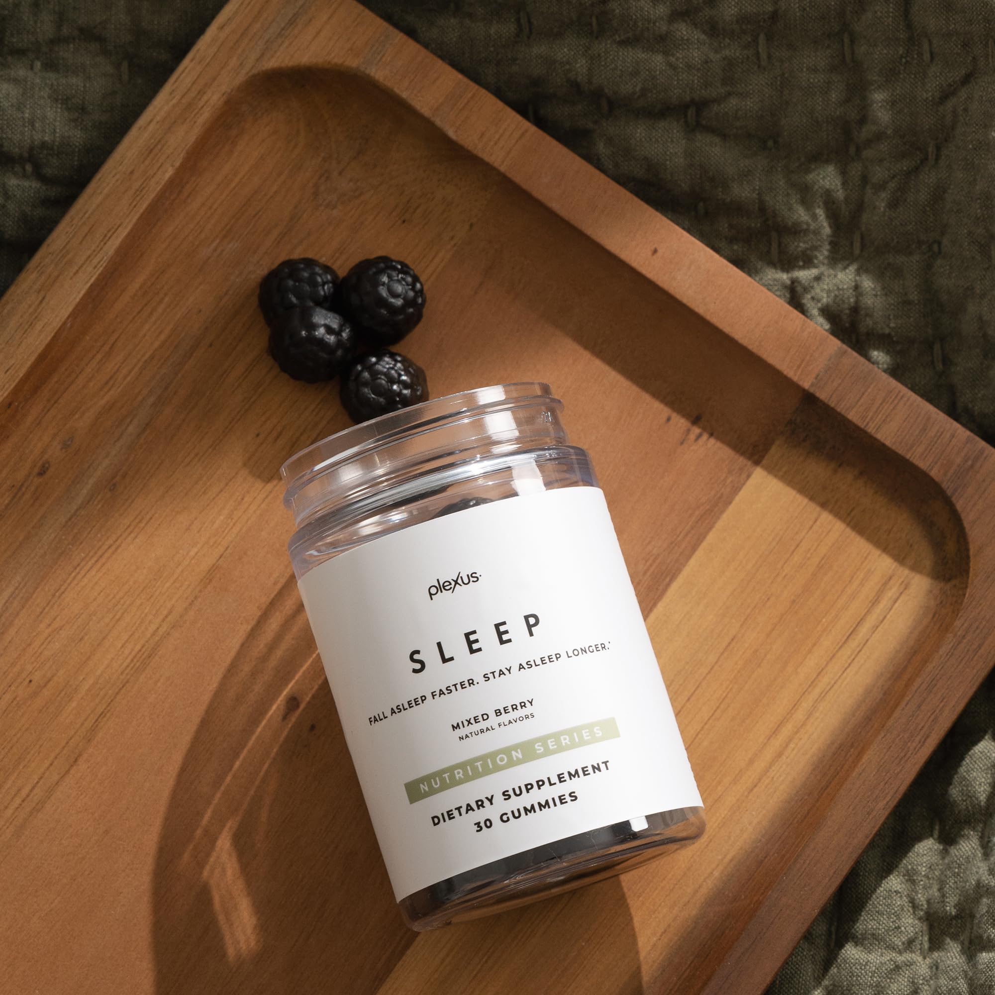 Plexus Sleep gummy on a dark surface with lavender accents for calm evenings.