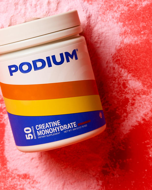 Podium Nutrition Solos Creatine Monohydrate being stirred into water for a refreshing workout drink