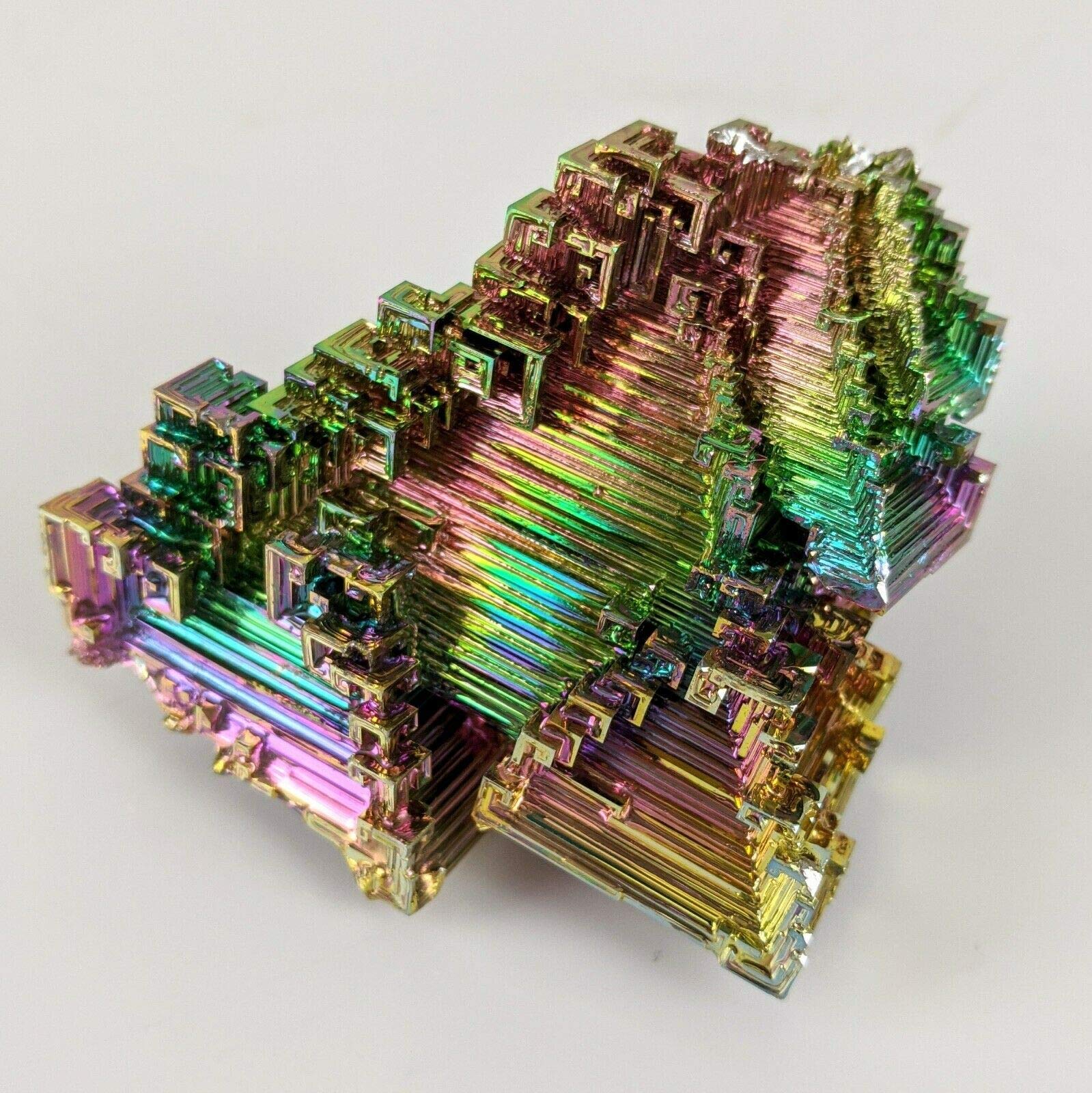Pounique Bismuth crystal with iridescent steps for meditative display.