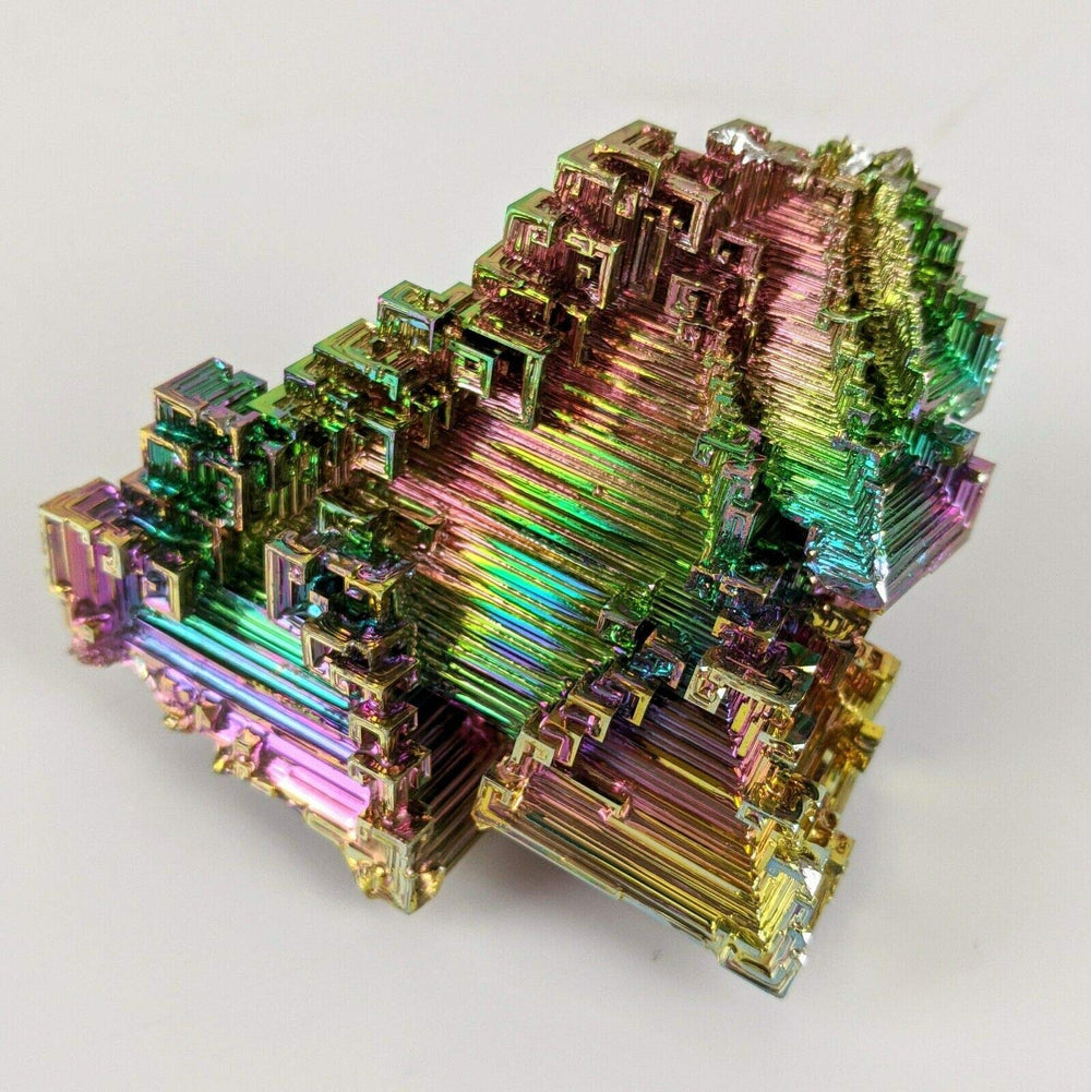 Pounique Bismuth crystal with iridescent steps for meditative display.