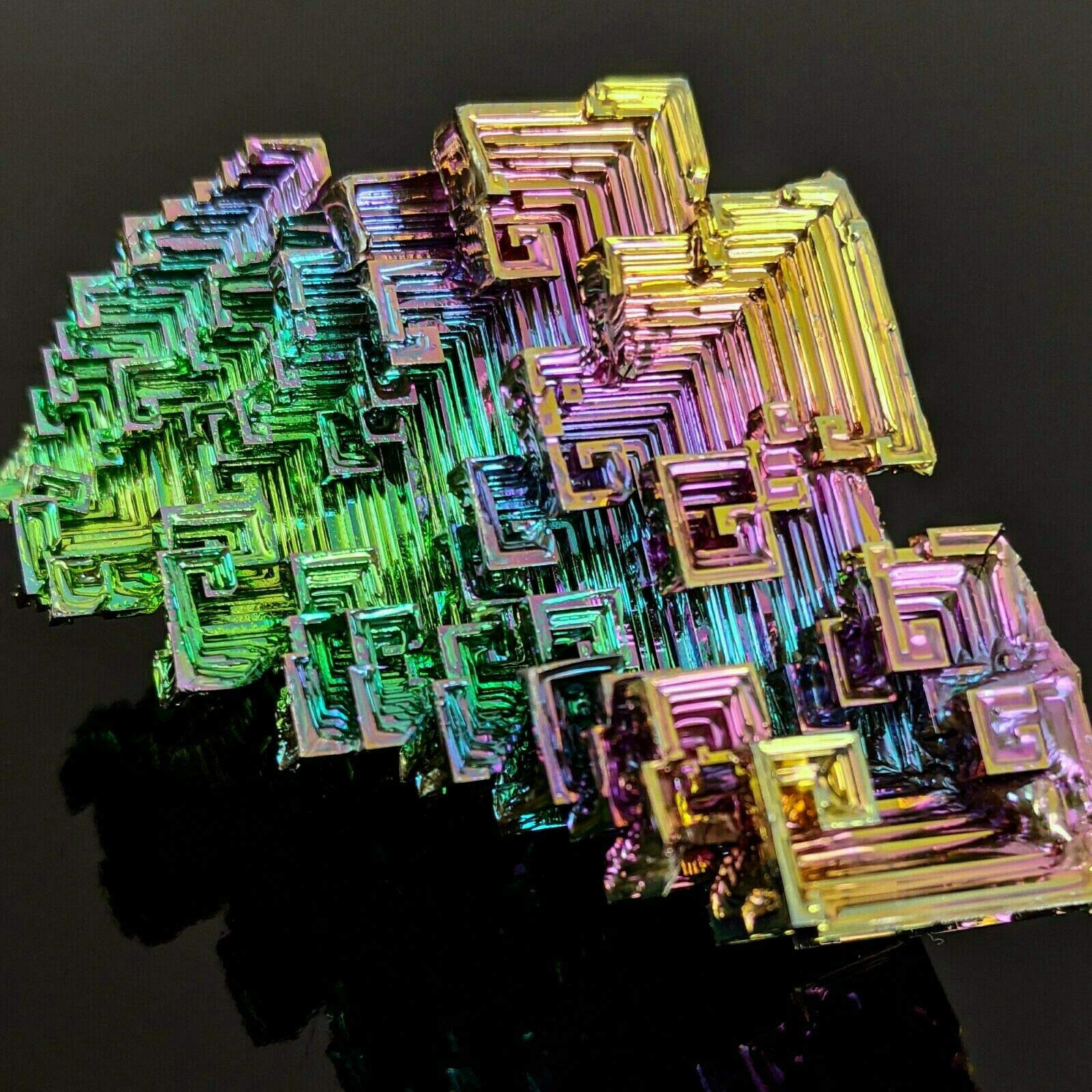 Pounique Bismuth crystal iridescent surface catches light for decorative glow.