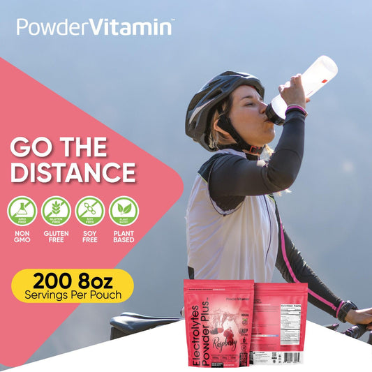 Scooping PowderVitamin Electrolytes Plus raspberry powder into water.