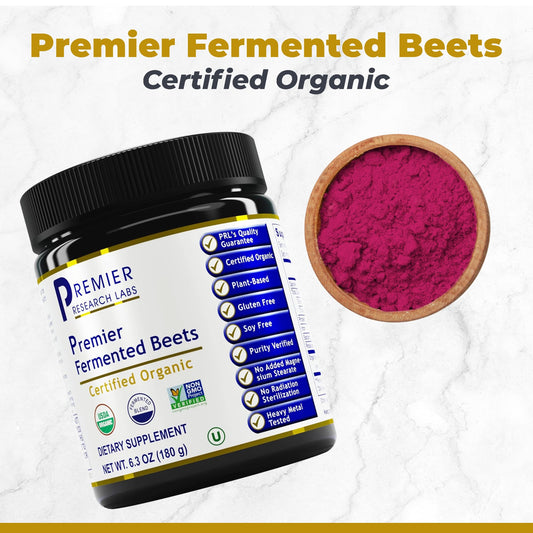 Beet root powder scoop beside a glass of juice for easy daily use by Premier Research Labs