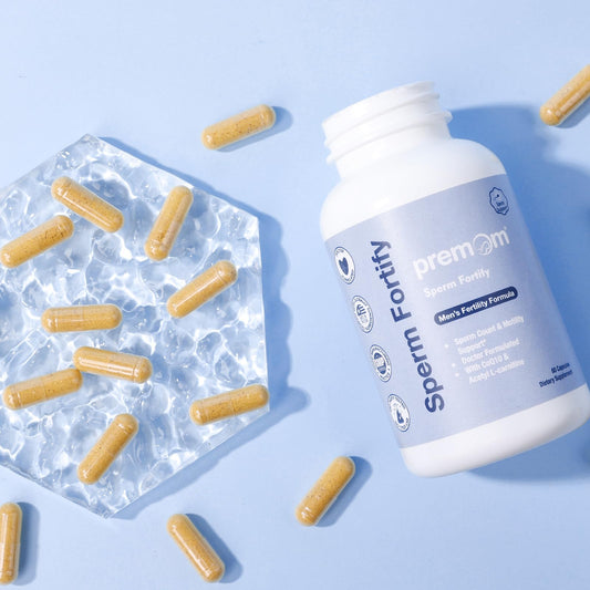 Premom Sperm Fortify capsules close-up demonstrates the two-capsule daily serving.