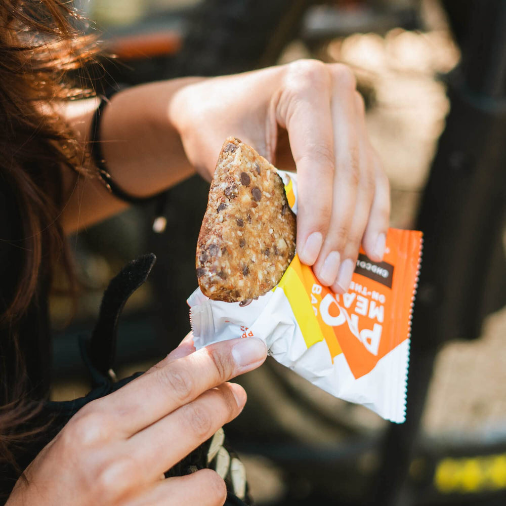 PROBAR MEAL Bar Chocolate Coconut cross-section shows oats and seeds.