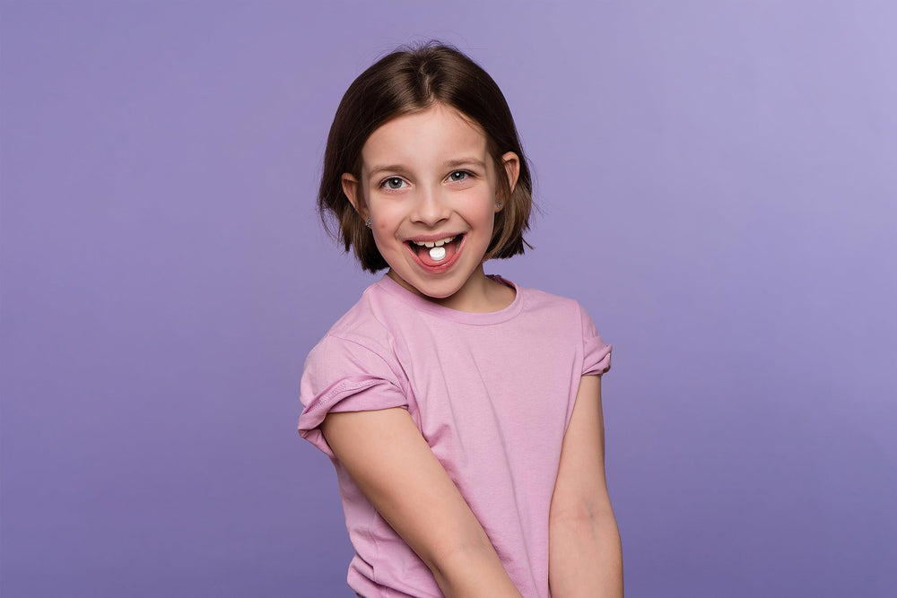 Probiora Kids smiling child demonstrates healthy-looking teeth.