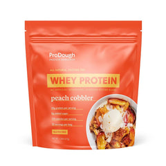 ProDough Peach Cobbler tub with premium flavor and 25g protein per serving.